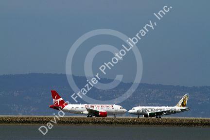 Airliners land and take off from San Francisco International Airport, California, USA.