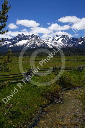 Split rail fencing and a fresh water creek running through a meadow near Stanley, Idaho, USA.