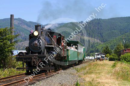 Tourists ride behind a 1910 Heisler Steam Locomotive at Garibaldi, Oregon, USA.