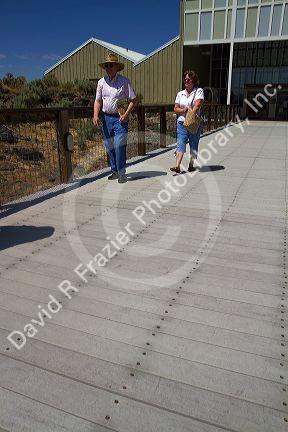 People walk on recycled plastic decking material at the National Historic Oregon Trail Interpretive Center near Baker City, Oregon, USA.