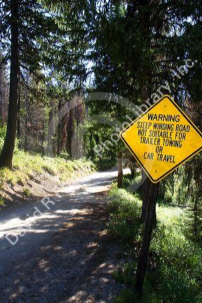 Sign warning of steep winding road ahead along the historic Magruder Corridor road that devides the Frannk Church-River of No Return Wilderness Area and the Selway-Bitterwoot Wilderness in Idaho, USA.