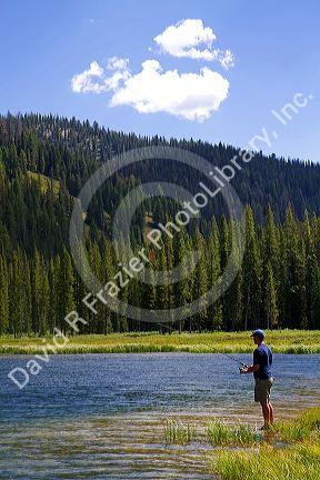 Fishing Bull Trout Lake located in the Boise National Forest near Lowman, Idaho, USA.