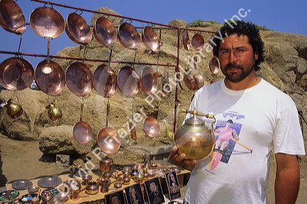 A man selling copper items in Chile.