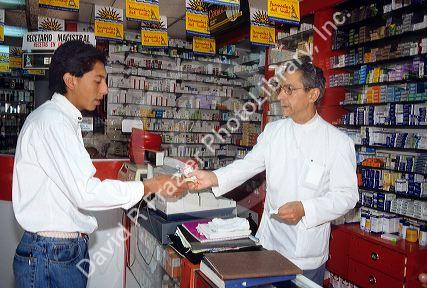 A man making a purchase at a drug store in Santiago, Chile.