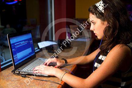 Girl using a laptop computer at a coffee shop in Boise, Idaho, USA.
