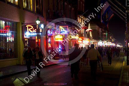 Neon signs of bars and restaurants along Bourbon Street in the French Quarter of New Orleans, Louisiana, USA.