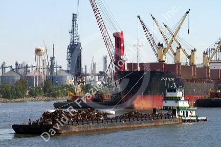Tug boat moving a barge filled with scrap metal on the Mississippi River at New Orleans, Louisiana, USA.