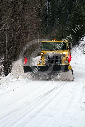 Snowplow removing snow from the road at Grimes Creek, Boise County, Idaho, USA.