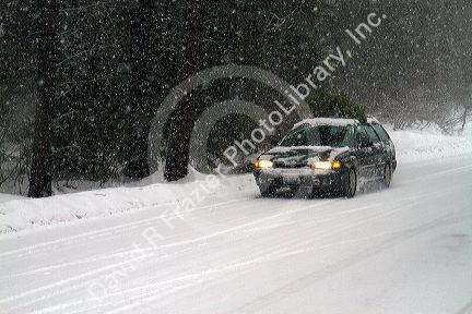 Winter driving in snow and ice at Mores Creek in Boise County, Idaho, USA.