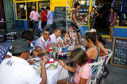 People dine at an outdoor cafe in the La Boca barrio of Buenos Aires, Argentina.