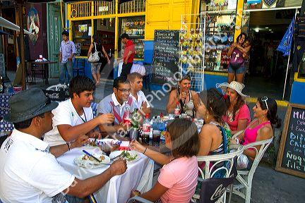 People dine at an outdoor cafe in the La Boca barrio of Buenos Aires, Argentina.