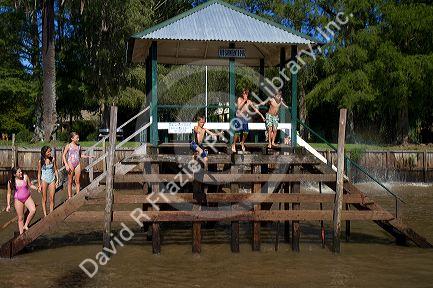 Children jumping into the Parana Delta at Tigre, Argentina.
