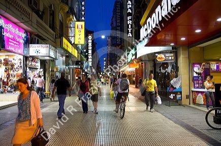 People walking on Lavalle Street at night in Buenos Aires, Argentina.