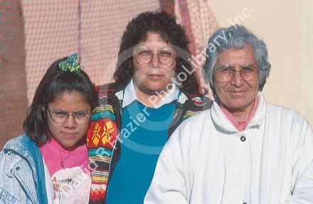 Three generations of Navajo Native American Indian women Grandmother, Mother, and Daughter.