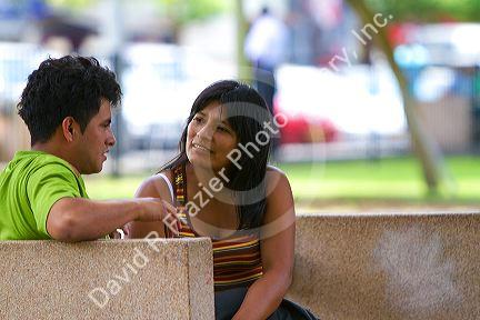 Couple having a conversation in Central Park of the Miraflores district of Lima, Peru.