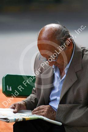 Man reading a newspaper in Buenos Aires, Argentina.