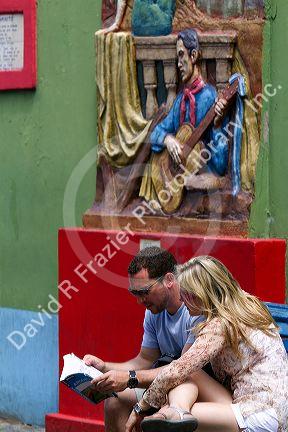 Tourists reading a guide book in the La Boca barrio of Buenos Aires, Argentina.