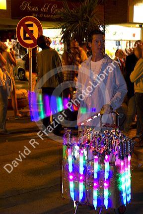 Street vendor selling glow sticks and toys at Necochea, Argentina.