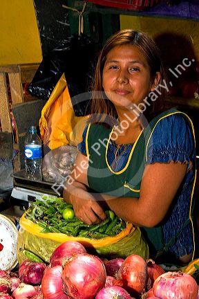 Vendor at a cooperative produce market in the Chorrillos district of Lima, Peru.