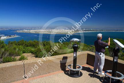 Tourists at a scenic overlook of San Diego and Coronado Island from Point Loma, California, USA.
