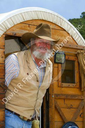 Muleskinner riding on a covered wagon at the City of Rocks National Reserve and state park in Cassia County, Idaho, USA. MR