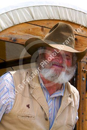 Muleskinner riding on a covered wagon at the City of Rocks National Reserve and state park in Cassia County, Idaho, USA. MR