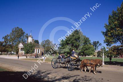 A horse drawn carriage with a view of the Court House in colonial Williamsburg, Virginia along Duke of Gloucester street.