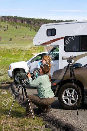 Mother and daughter viewing wildlife in Yellowstone National Park, USA. MR