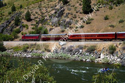 The Thunder Mountain Line scenic tourist train traveling along the Payette River between Horseshoe Bend and Banks, Idaho, USA.