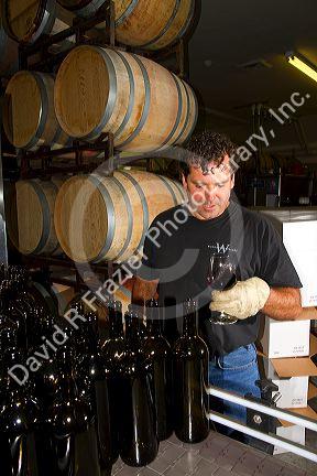 Winemaker tasting red wine at Woodriver Cellars in Eagle, Idaho, USA.