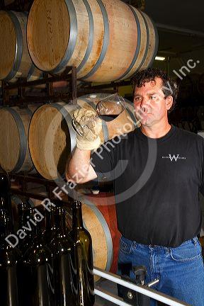 Winemaker tasting red wine at Woodriver Cellars in Eagle, Idaho, USA.