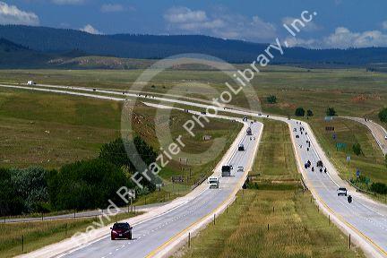 Motorcycles and automobiles travel on I-90 west of Spearfish, South Dakota, USA.