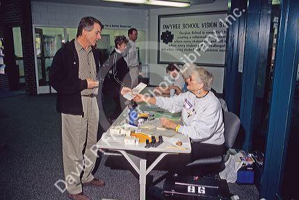 A voter being handed a ballot at an election precinct in Boise, Idaho.