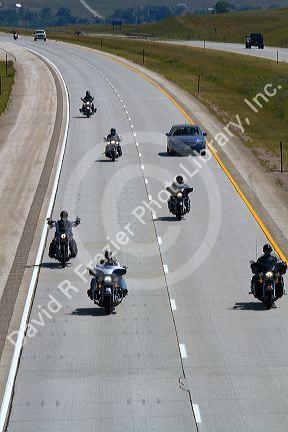 Motorcycles and automobiles travel on I-90 during Sturgis Motorcycle rally week west of Spearfish, South Dakota, USA.