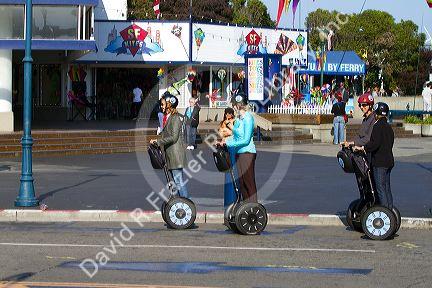 People ride a Segway PT near Pier 39 in San Francisco, California, USA.