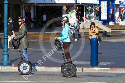 People ride a Segway PT near Pier 39 in San Francisco, California, USA.