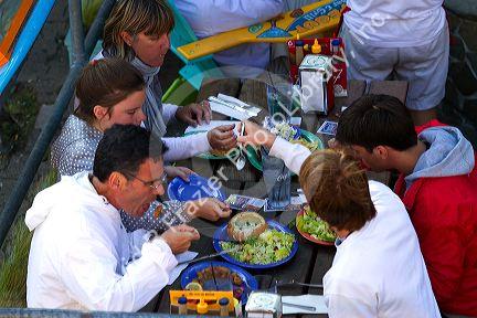 People dine outdoors at a restaurant on Pier 39 in San Francisco, California, USA.