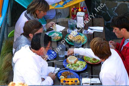 People dine outdoors at a restaurant on Pier 39 in San Francisco, California, USA.