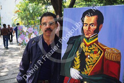 An artist with a painting of Simon Bolivar in Venezuela.