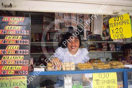 A woman clerk working in a candy stand, Venezuela.