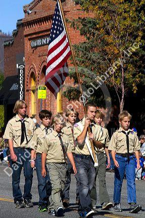 Boy Scout honor guard walking in the Trailing of the Sheep Parade on Main Street in Ketchum, Idaho, USA.