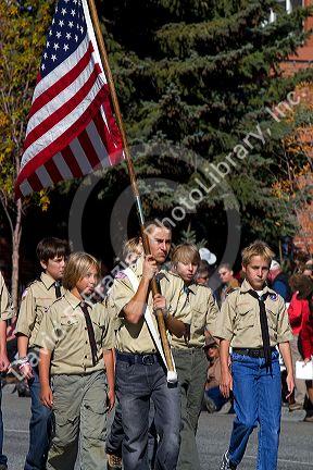Boy Scout honor guard walking in the Trailing of the Sheep Parade on Main Street in Ketchum, Idaho, USA.