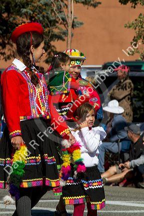 Peruvian people in traditional dress take part in the Trailing of the Sheep Parade on Main Street in Ketchum, Idaho, USA.
