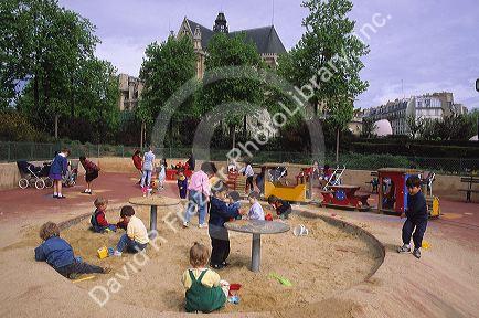 French children attend preschool and play outside on the playground in Paris, France.