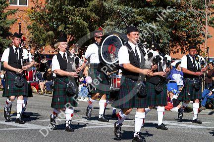 The Boise Highlanders playing bagpipes and drums in the Trailing of the Sheep Parade on Main Street in Ketchum, Idaho, USA.