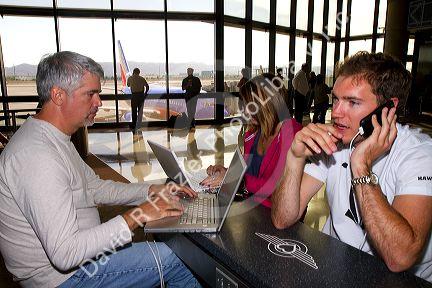 People use wi-fi internet at the Phoenix Sky Harbor International Airport located in the city of Phoenix, Arizona, USA.