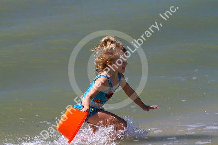 Four year girl playing at Madeira Beach in Pinellas County, Florida, USA.