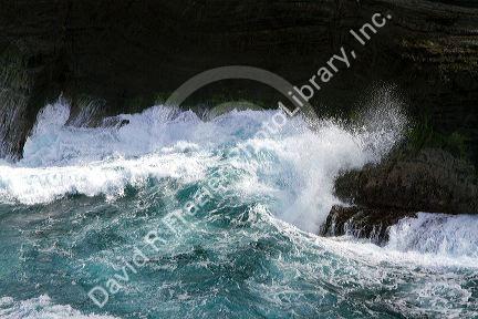 Pacific ocean waves crash against the lava peninsula of Kilauea Point National Wildlife Refuge on the island of Kauai, Hawaii, USA.
