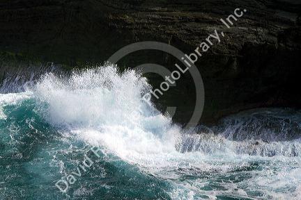 Pacific ocean waves crash against the lava peninsula of Kilauea Point National Wildlife Refuge on the island of Kauai, Hawaii, USA.