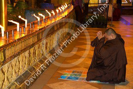 Buddhist monk praying at the Shwedagon Paya located in (Rangoon)Yangon, (Burma) Myanmar.